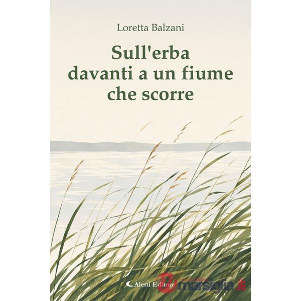 Sull'erba davanti a un fiume che scorre